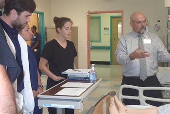 Dr. José Rojas works with students during a simulation.