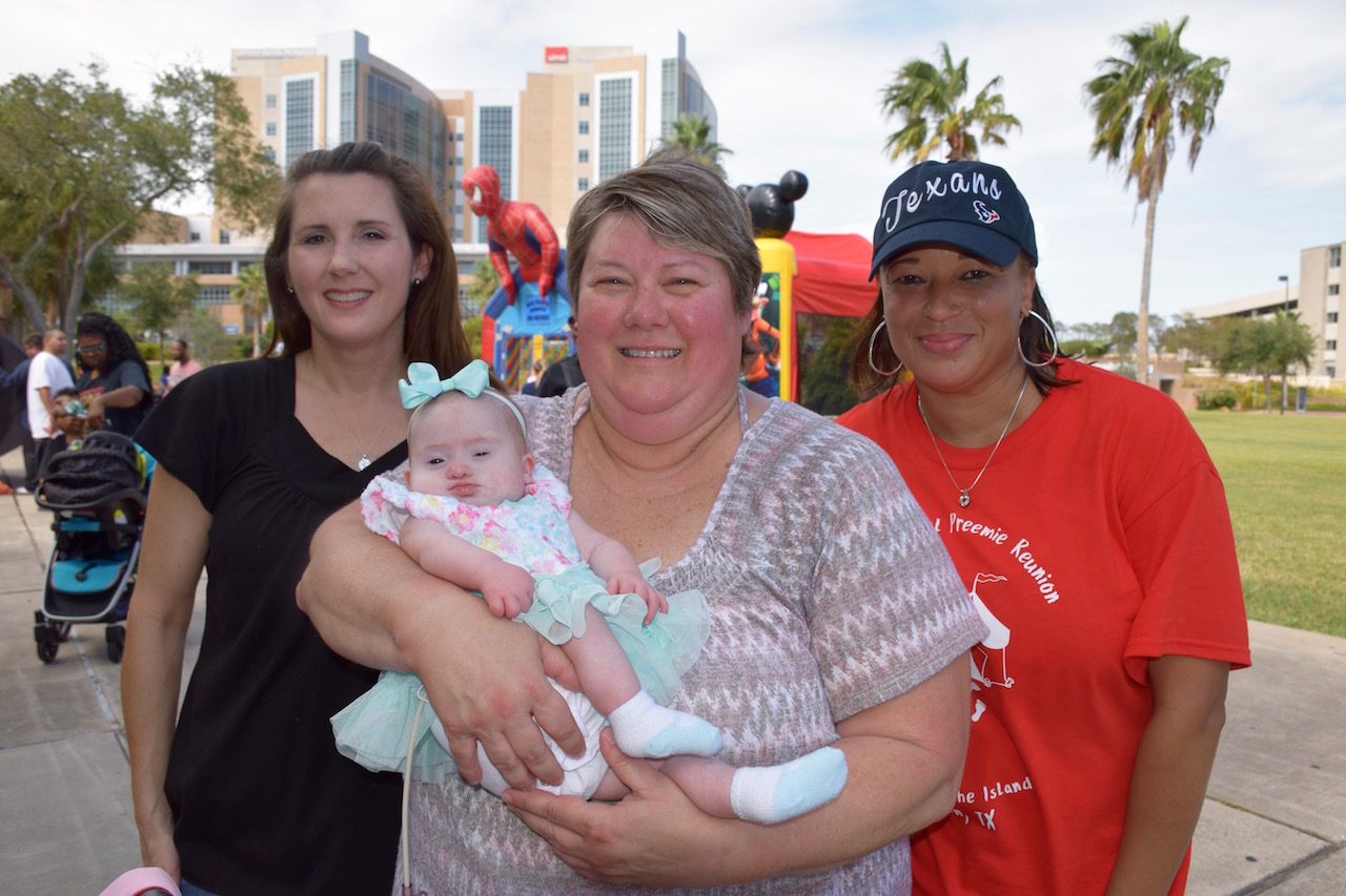 Wendy Lentino (left) and her daughter, Lily, reunite with NICU nurses Carrie Holloway (middle) and Lavonda Morgan.