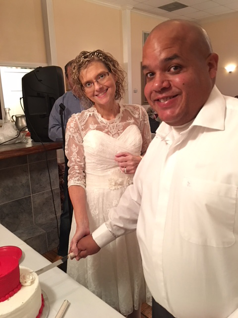 Amanda and Keith Johnson smile for a photo as they cut into their vow renewal cake.