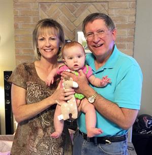 Garwood and his wife with their grandchild, Claire. 