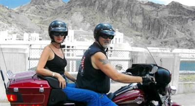 Marcel Blanchard and his wife, Debbie, ride a motorcycle across the Hoover Dam.