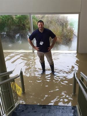 Dean Leathers, an environmental protection specialist, stands on the bottom floor of the Materials Management Warehouse during Harvey. 