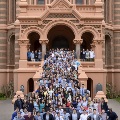 Group of people posing on steps of Ashbel Smith Building