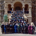 Faculty in regalia posing on steps of Ashbel Smith Building