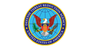 Circular seal of the Defense Threat Reduction Agency featuring a bald eagle over a globe with the words “Defense Threat Reduction Agency, United States of America.”