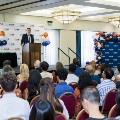 Dr. Bianco speaking on stage in front of audience