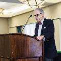 Dr. Coller speaking on stage