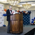 Dr. Coller speaking on stage