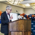 Dr. Coller speaking on stage