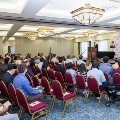 Dr. Coller speaking on stage in front of audience