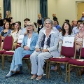 Dr. Bush and Dr. Rastellini sitting at the front row of the audience