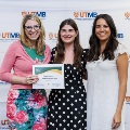 ΑΩΑ Student Vice President, Erin Guerra, and ΑΩΑ Student Treasurer, Gabrielle Hyde, presenting Faculty and House Staff Inductee Charlena Melnyk, MD