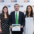 ΑΩΑ Student Vice President, Erin Guerra, and ΑΩΑ Student Treasurer, Gabrielle Hyde, presenting Faculty and House Staff Inductee Ibrahim Mortada, MD