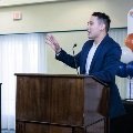 Alpha Omega Alpha Student President, Gabriel Rivera, speaking on stage