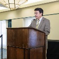 Alpha Omega Alpha Faculty Councilor, Bernard M. Karnath, MD, delivering a speech on stage