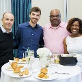 Alpha Omega Alpha attendees posing around a table