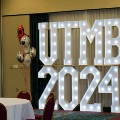 Illuminated “UTMB 2024” letters displayed with red, white, and gold balloon decorations in an indoor event setting for an Alpha Omega Alpha Texas Alpha Chapter celebration.