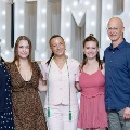 Five individuals standing together in front of illuminated “UTMB” letters with red, white, and gold balloons during an Alpha Omega Alpha Texas Alpha Chapter event at the University of Texas Medical Branch.