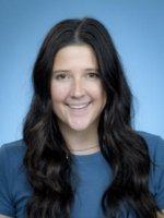 Professional headshot of Bethany King with long curly black hair, wearing a blue top
