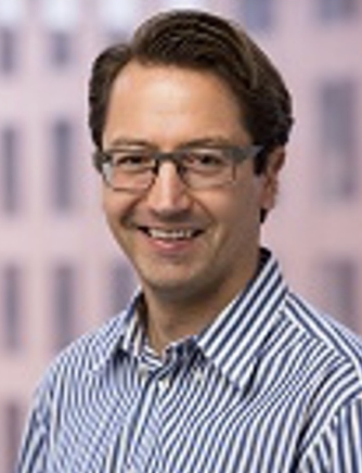 man wearing glasses and a striped shirt, smiling