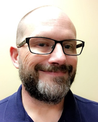 man wearing glasses smiling