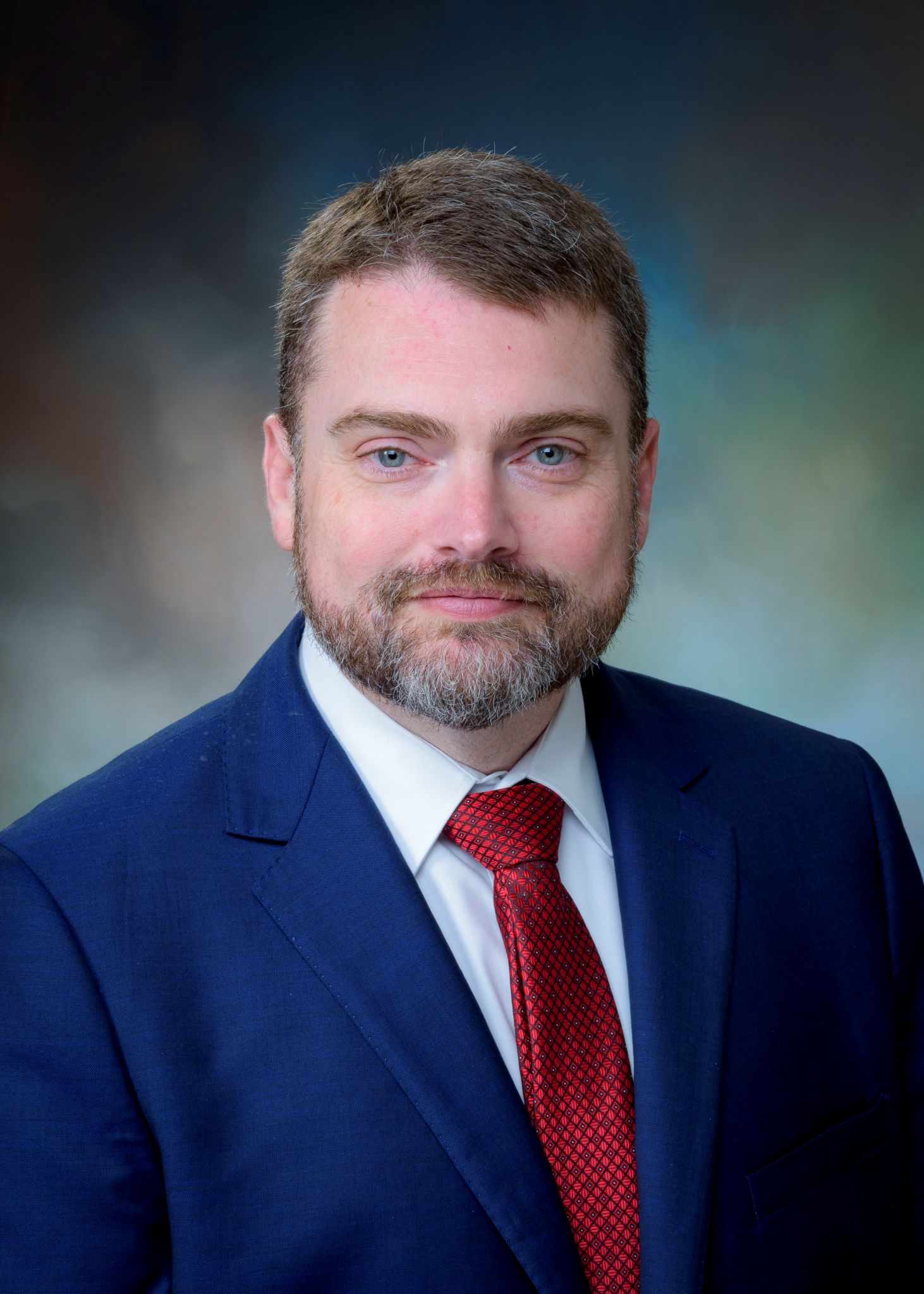 Krouse, Andy28 1462 headshot with blue suit and red tie
