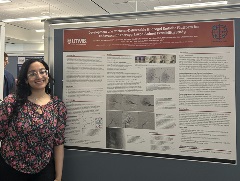 Person standing next to a UTMB neurosurgery research poster during a presentation session, displaying figures and text on an endovascular therapy feasibility study in a conference-style environment.
