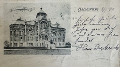 Black and white photograph of an ornate three storied building with arched brick work. Handwritten annotation on the right dated 1899.