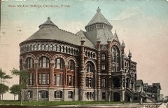 Colorized photograph A large historic red‑brick Romanesque Revival building with arched windows, decorative stone bands, steep slate roofs, and turreted towers.