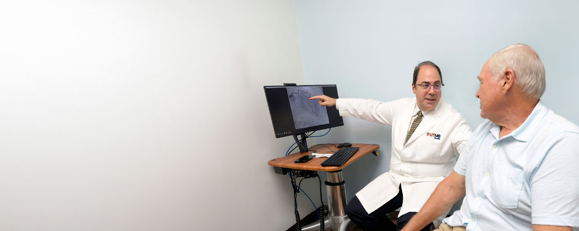 Dr. Jneid speak with a patient about heart health