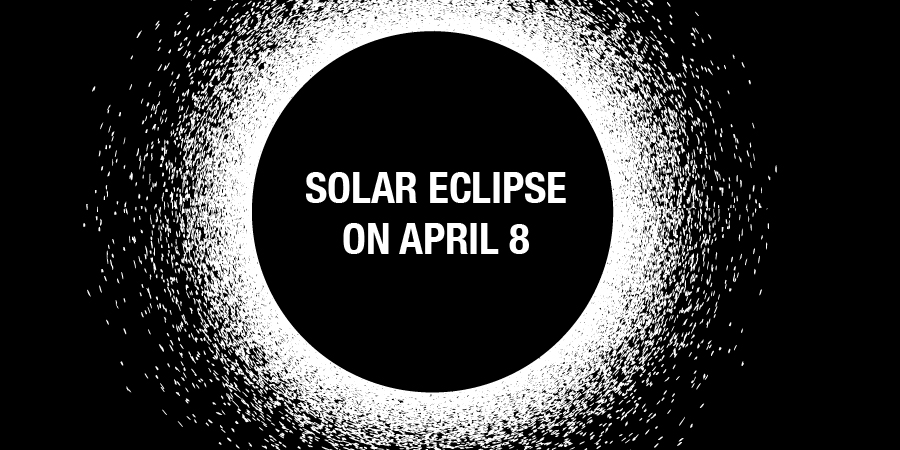 Black full moon covers the sun leaving a white glowing ring