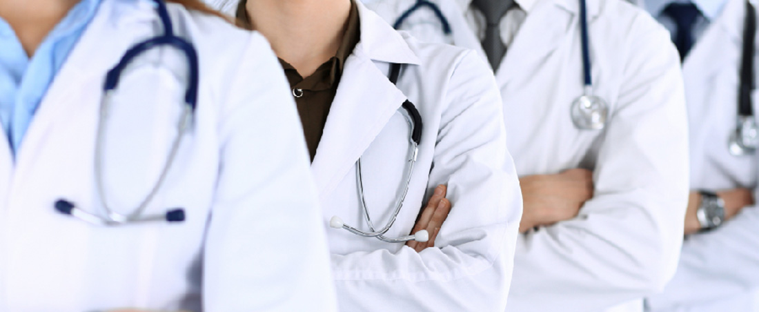 Close up of stethoscope hanging over doctor's shoulders