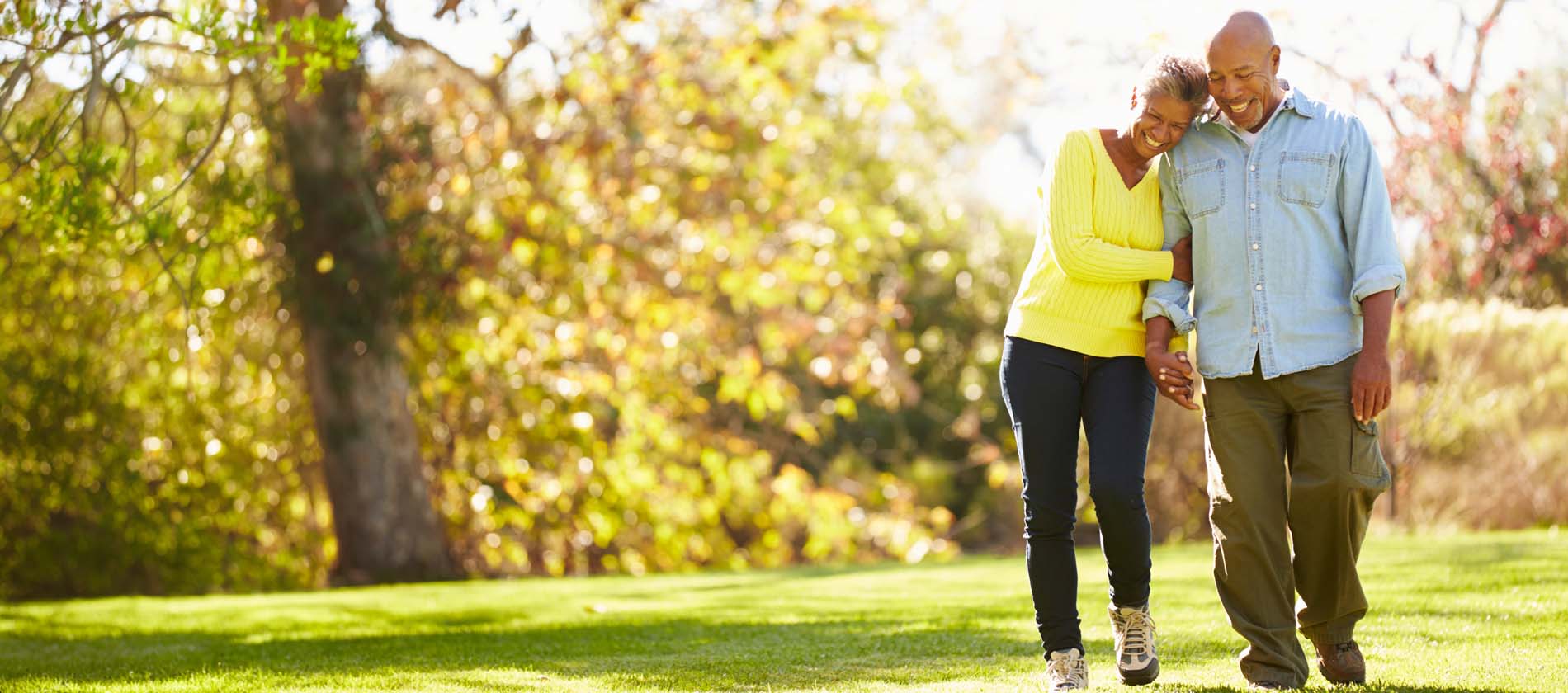 Two adults walk together outdoors showing balance mobility and support during recovery after stroke or vascular care.