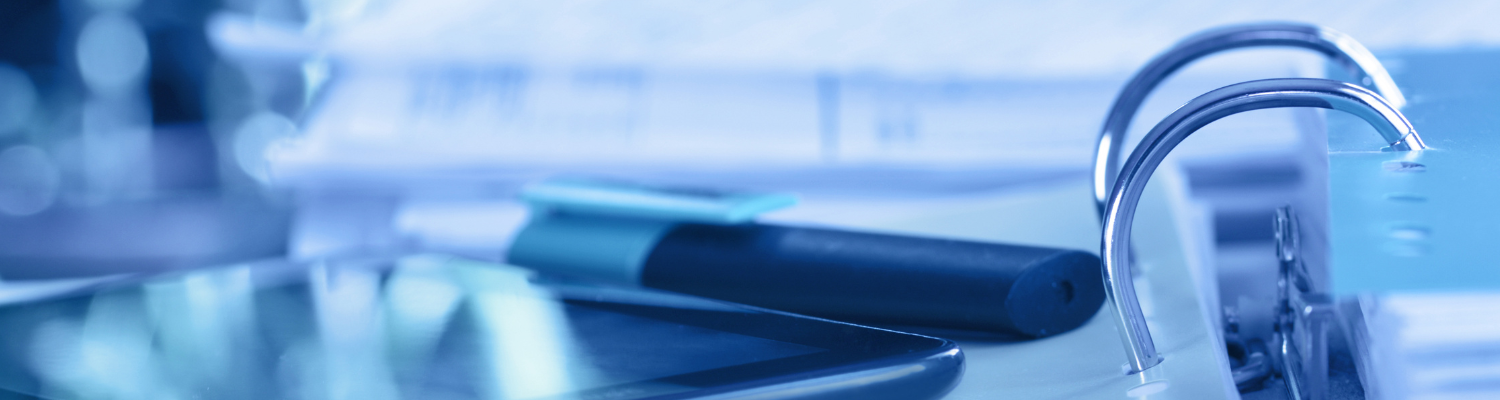 Closeup of a 3 ring binder and a highlighter