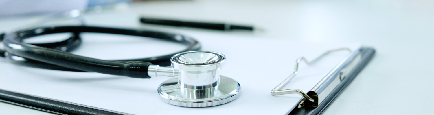 A stethoscope on top of a clipboard