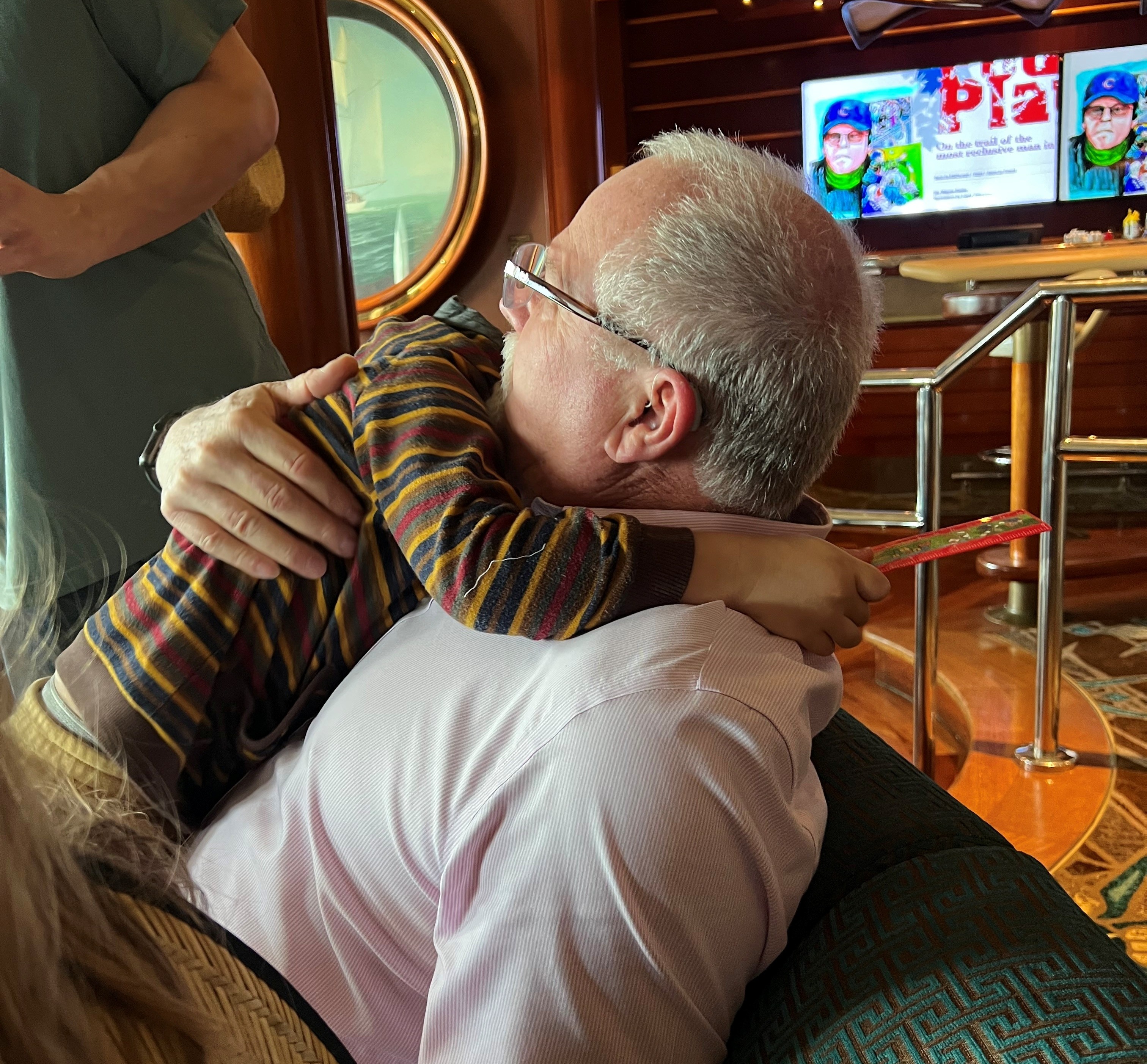 young boy hugging older gentleman