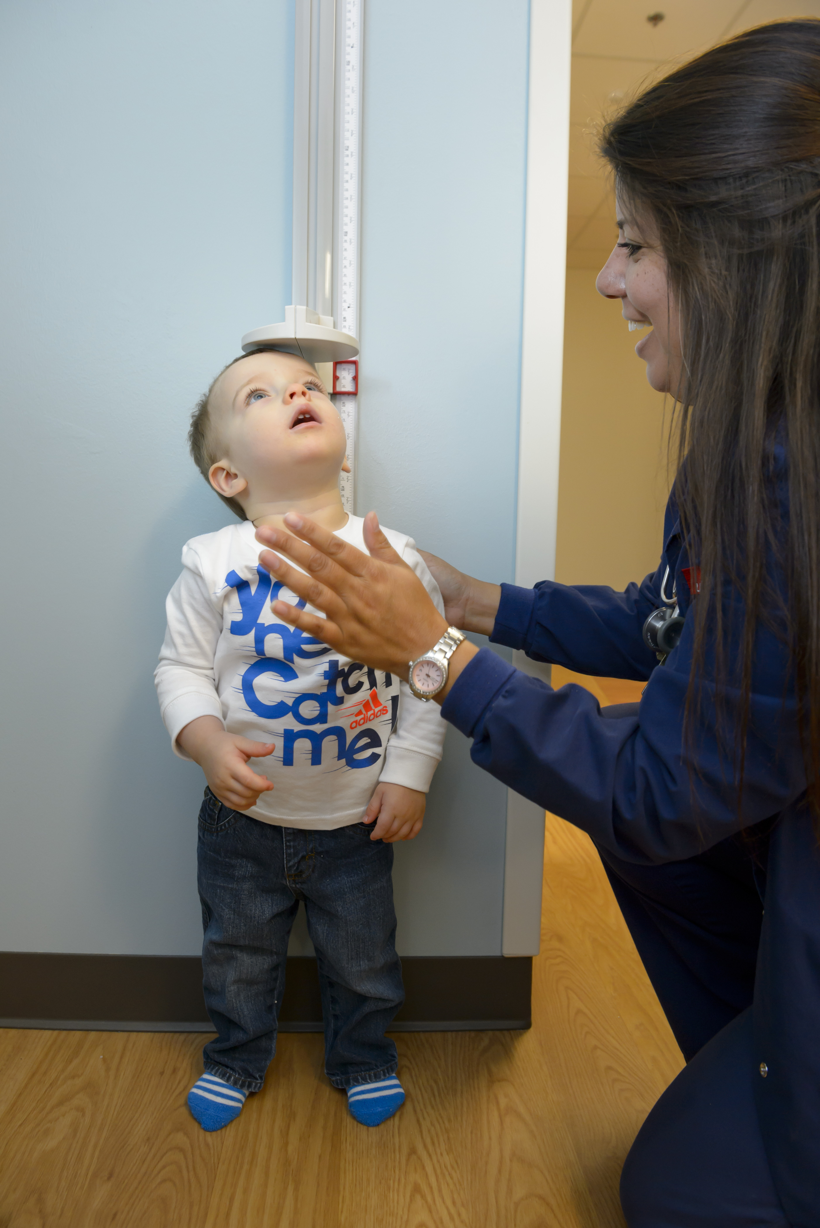 Toddler boy getting measured