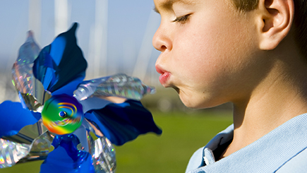 Child Blowing a wind mill
