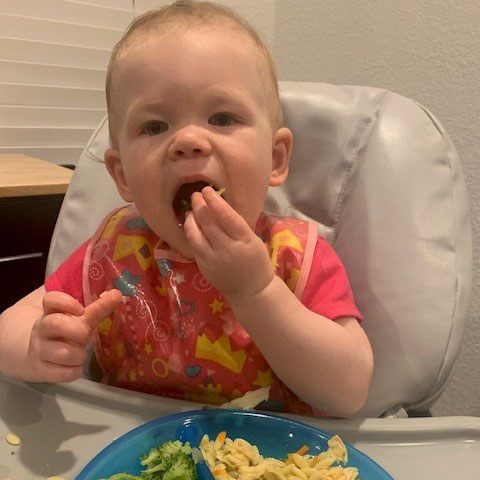 Baby eating from highchair