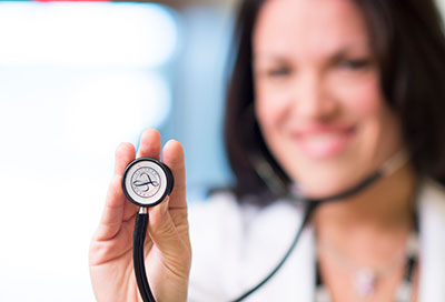 Dr. ManuelaMurray holding a stethoscope
