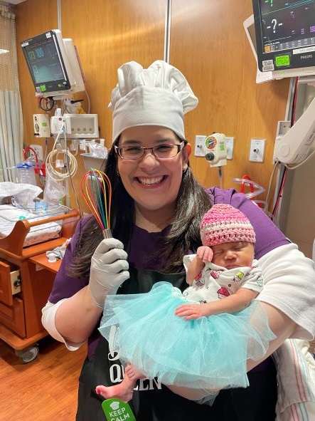 Maria in NICU holding baby in costume