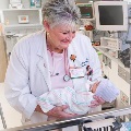 NICU Dr. Richardson holding small baby in NICU
