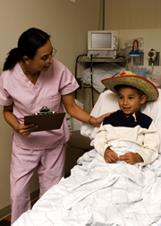nurse_boy-with-cowboy-hat-in-bed