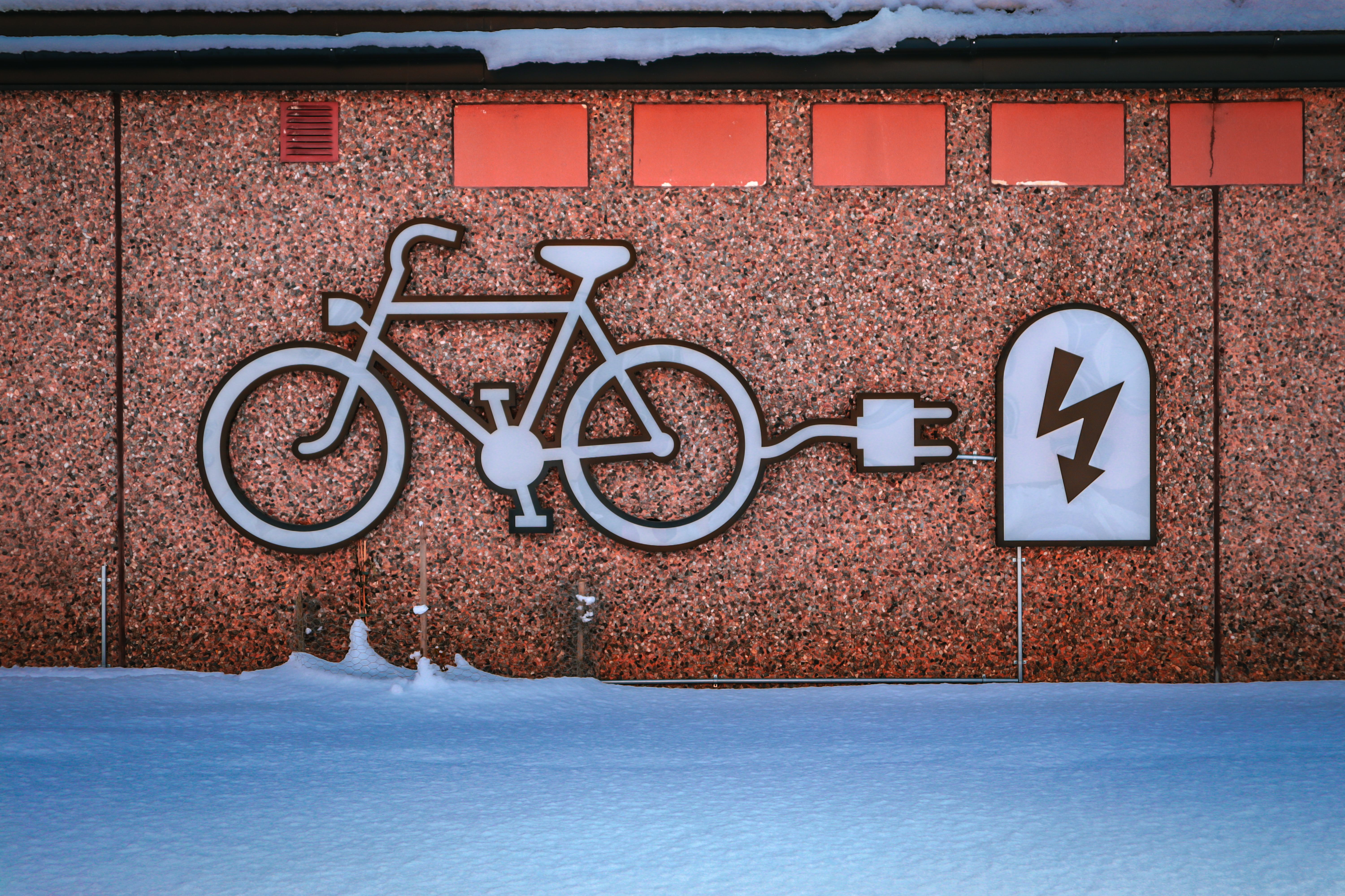 pexels-damir-15884318 ebike with charger on wall