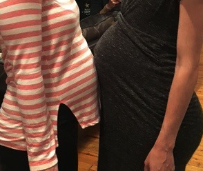 2 women with pregnant bellies touching