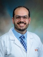 Muttaz Abusamra headshot in white coat