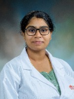 Angidi, Divija headshot in white coat