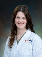 Sarah Woods head shot in white coat