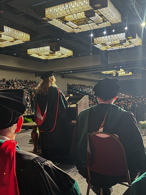 Photo of UTMB Health Family Medicine & Community Health faculty member delivering  Physicians Oath at the 2026 UTMB JSSOM Graduation Ceremony