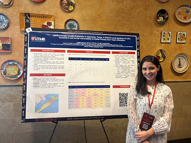 Photo of Master's Student Paulina Alcocer in front of her poster presentation at the AHA and UTMB Cardiovascular Symposium 2026
